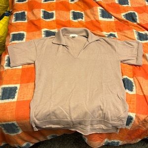 Beige tee with a v-neck opening.